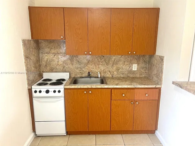 a kitchen with granite countertop cabinets and white appliances
