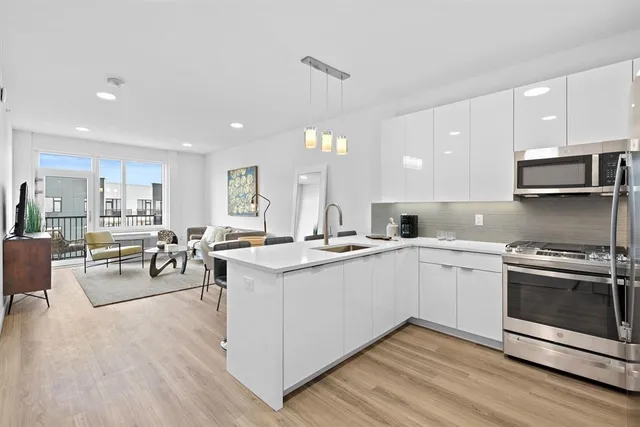 a kitchen with a sink stove and cabinets