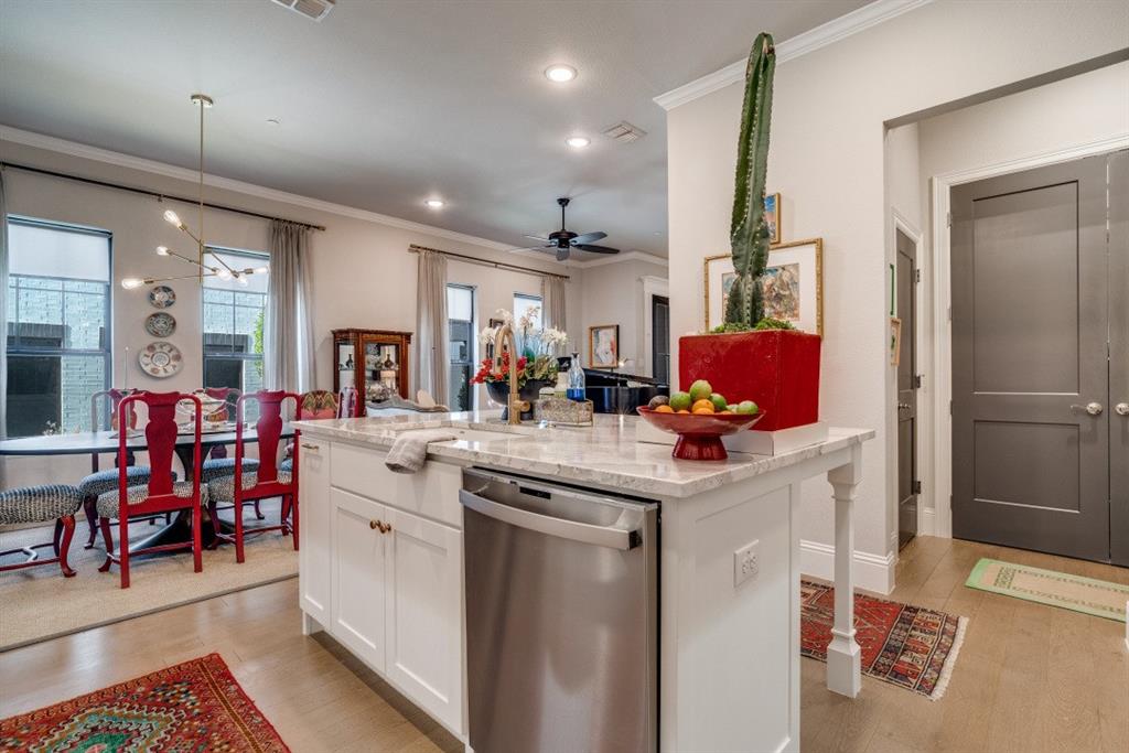 307 Sunset Lane, Unit 101 Fort Worth, TX 76114 - Photo 11 of 37 a kitchen with stainless steel appliances kitchen island granite countertop a sink and cabinets