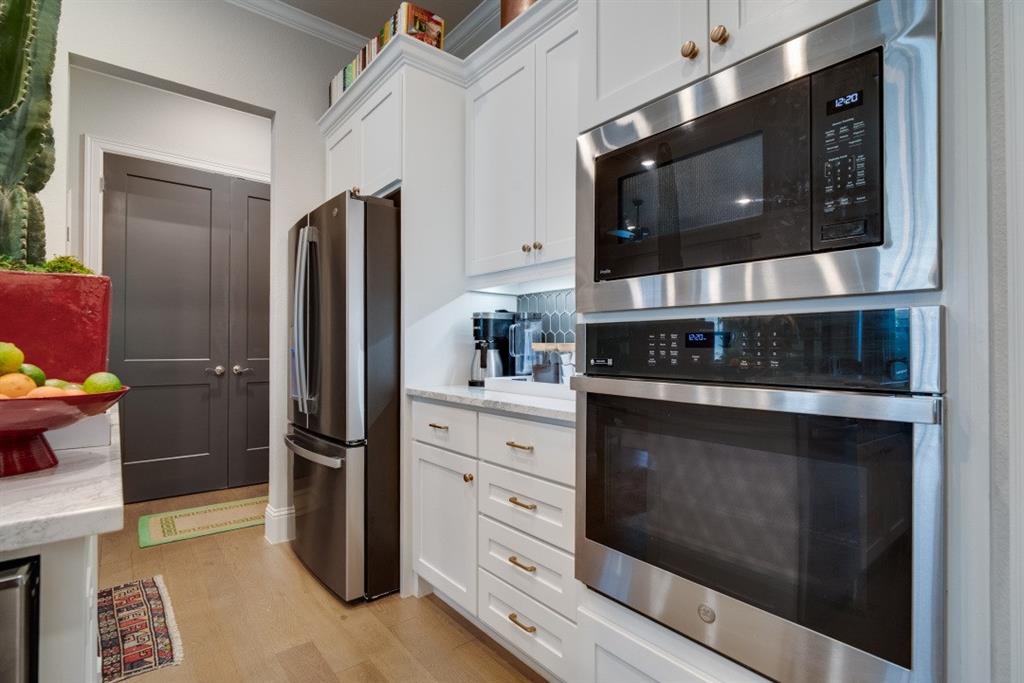 307 Sunset Lane, Unit 101 Fort Worth, TX 76114 - Photo 12 of 37 a kitchen with stainless steel appliances a stove a microwave and cabinets