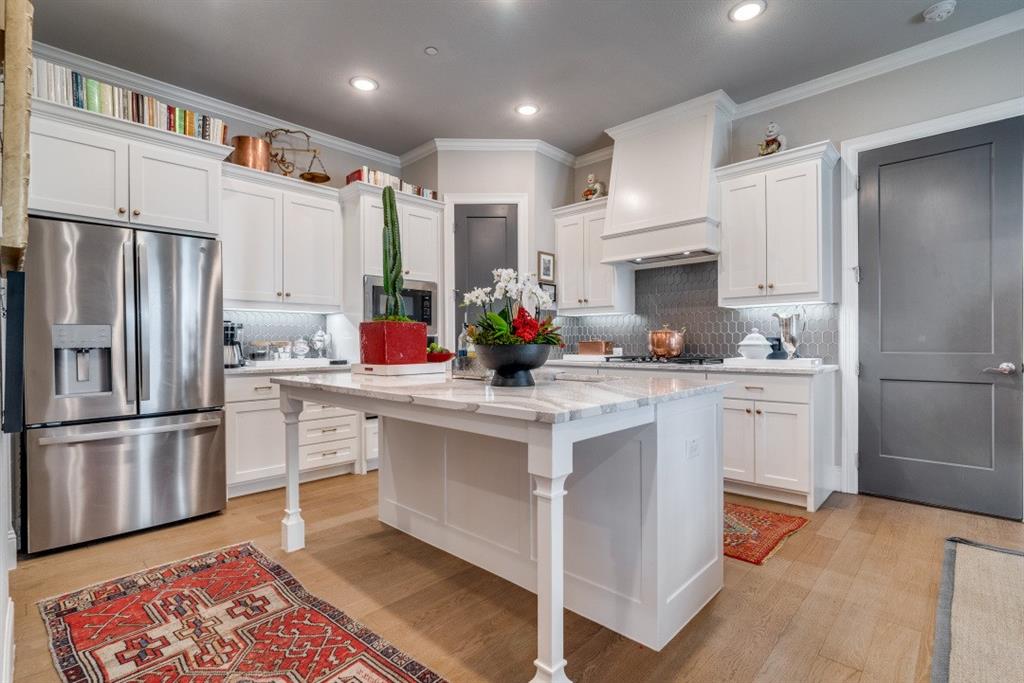 307 Sunset Lane, Unit 101 Fort Worth, TX 76114 - Photo 13 of 37 a kitchen with white cabinets and stainless steel appliances