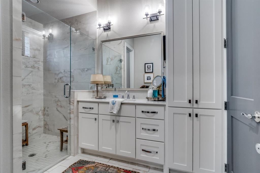 307 Sunset Lane, Unit 101 Fort Worth, TX 76114 - Photo 16 of 37 a bathroom with a shower sink and mirror