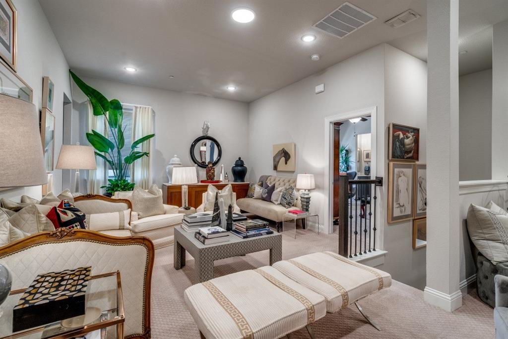 307 Sunset Lane, Unit 101 Fort Worth, TX 76114 - Photo 19 of 37 a living room with furniture a rug and a chandelier