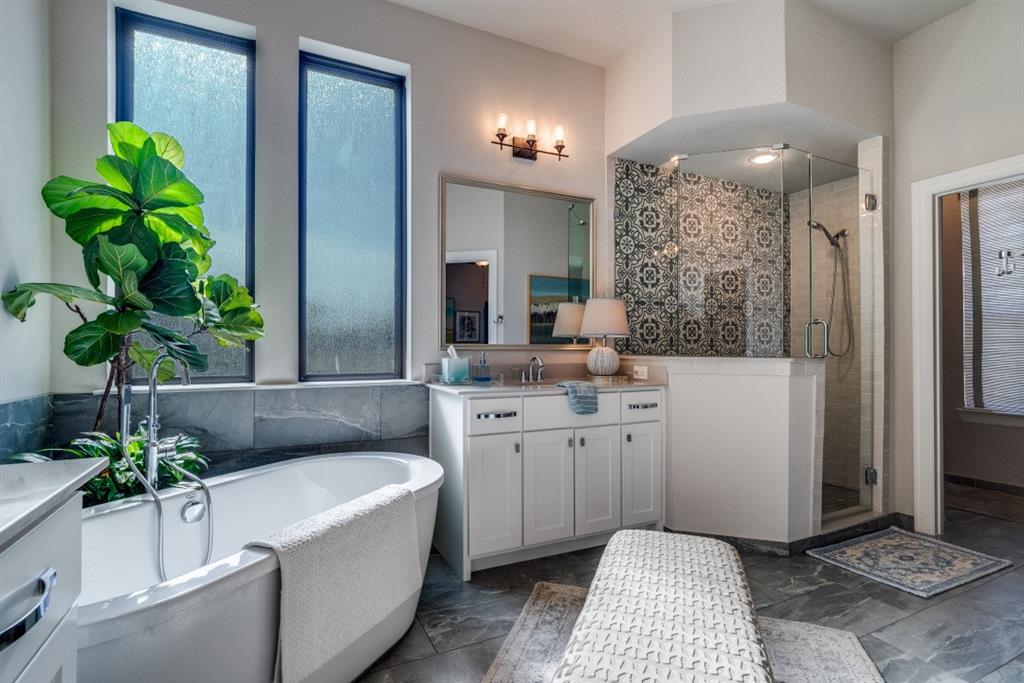 307 Sunset Lane, Unit 101 Fort Worth, TX 76114 - Photo 26 of 37 a spacious bathroom with a tub a sink and a mirror