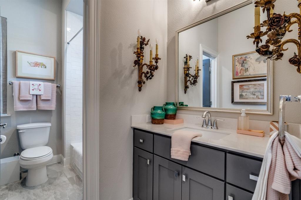 307 Sunset Lane, Unit 101 Fort Worth, TX 76114 - Photo 30 of 37 a bathroom with a toilet a sink and mirror