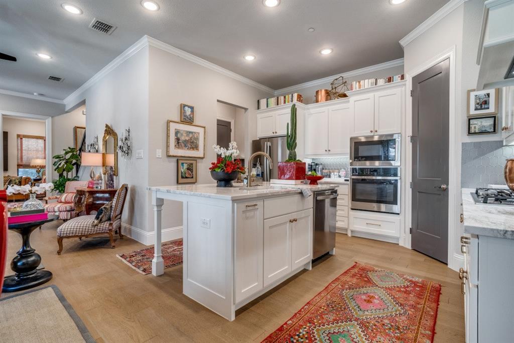 307 Sunset Lane, Unit 101 Fort Worth, TX 76114 - Photo 7 of 37 a kitchen with stainless steel appliances kitchen island granite countertop a refrigerator and a stove