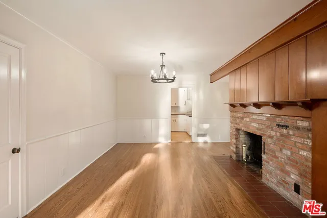 a view of a kitchen with wooden floor and electronic appliances