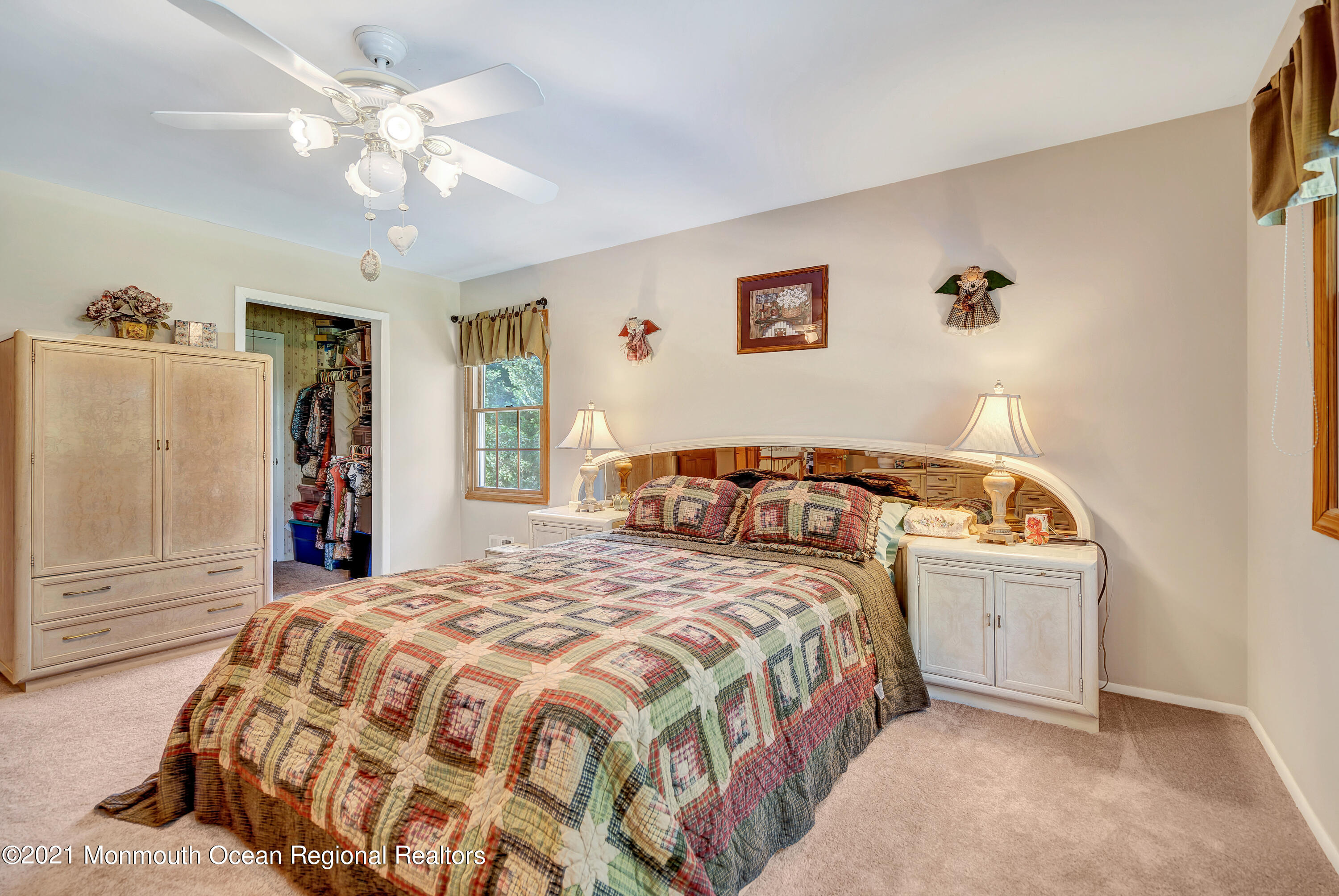 25 High Ridge Road Howell, NJ 07731 - Photo 22 of 38 a bedroom with a large bed and a chandelier