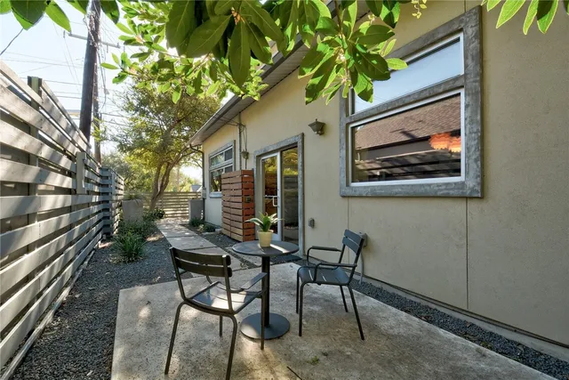 a view of a house with backyard and sitting area