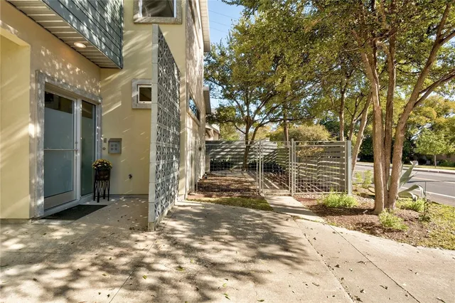 a view of a house with a tree in the background