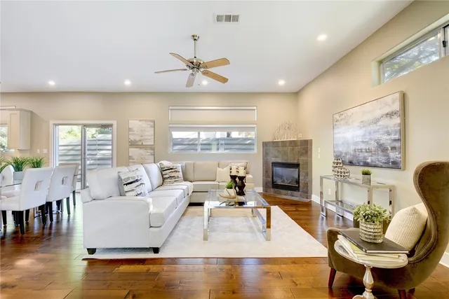 a living room with furniture fireplace and a large window