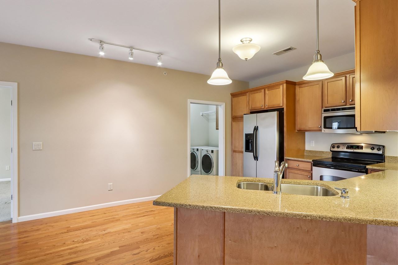 856 Foster Road Iowa City, IA 52245 - Photo 13 of 39 View from Breakfast bar into kitchen and pantry/laundry room