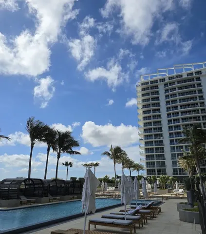 a open kitchen with stainless steel appliances kitchen island granite countertop a refrigerator and cabinets