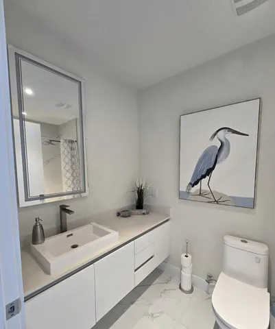 a bathroom with a sink toilet and shower