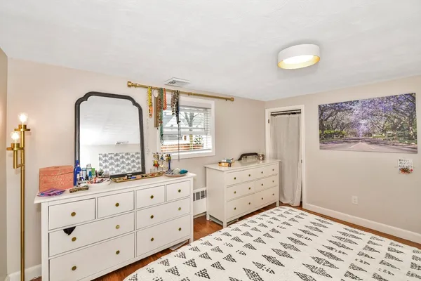 a bedroom with a bed and a dresser