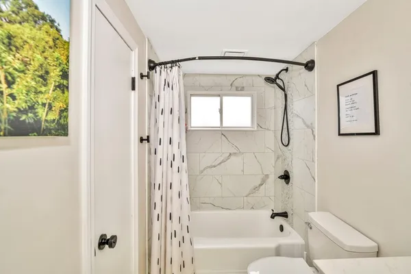 a bathroom with a shower and a bathtub