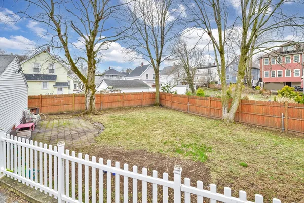 a view of a backyard with a large tree