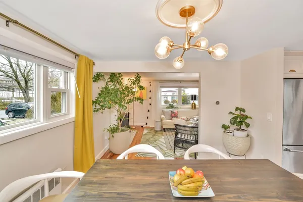 a living room with dining table furniture and a large window