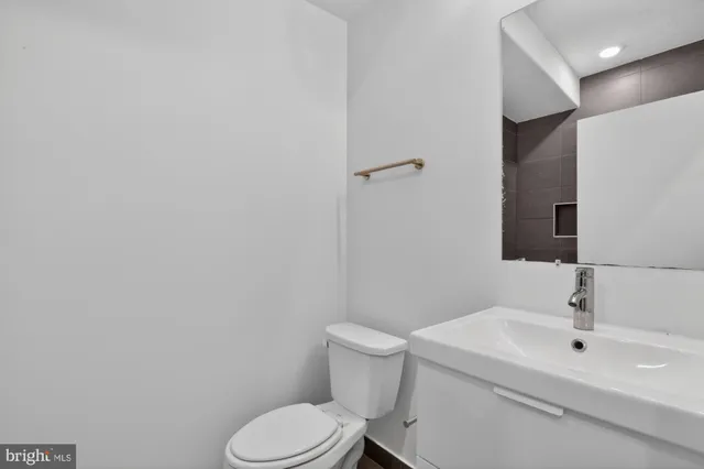 a white toilet sitting next to a bathroom sink