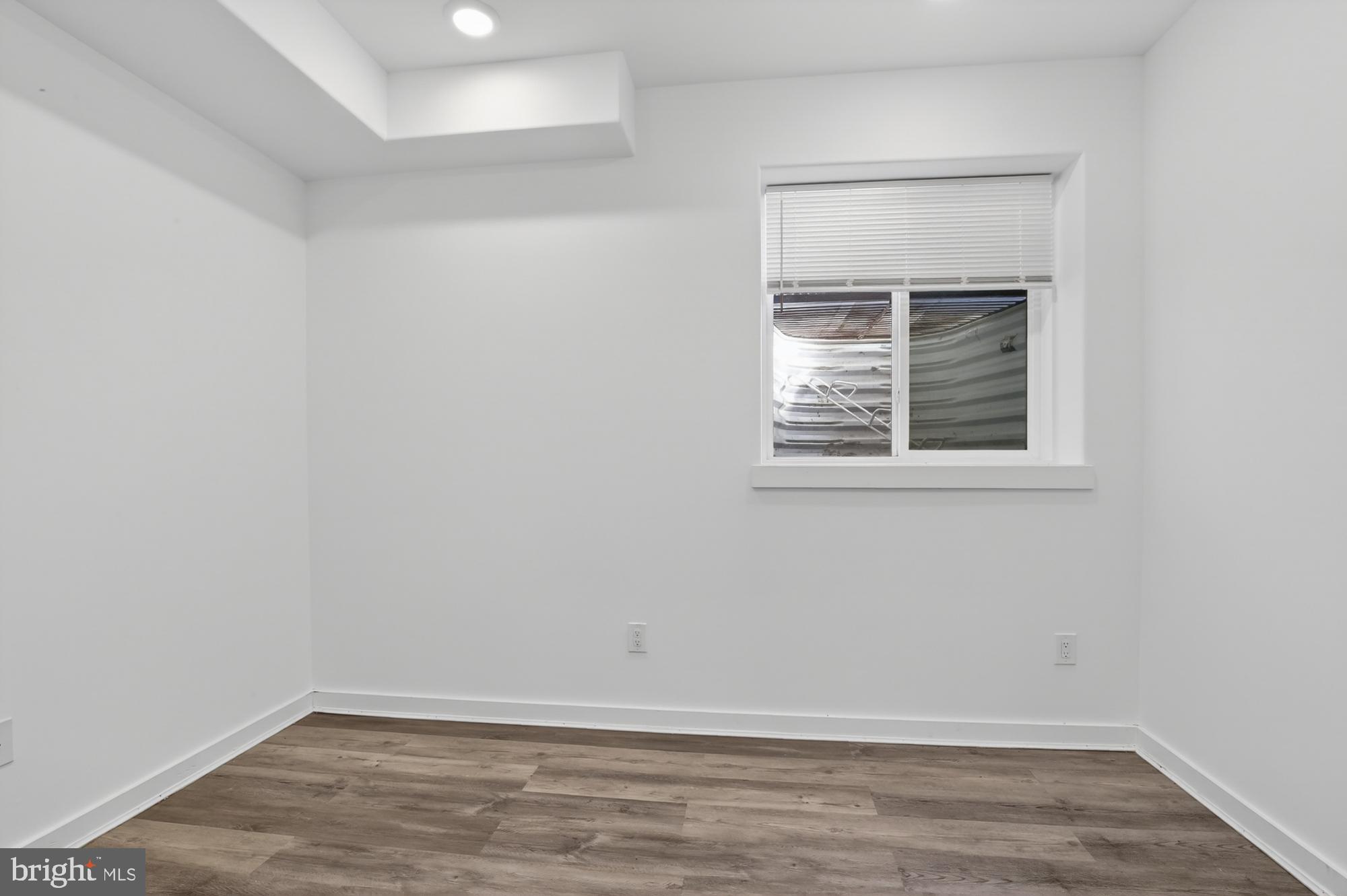1445 South 32nd Street, Unit 1 Philadelphia, PA 19146 - Photo 19 of 23 a view of an empty room with wooden floor and a window