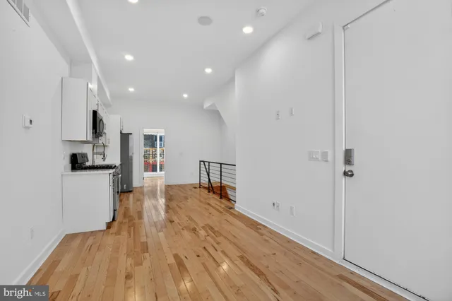a view of kitchen with cabinets and wooden floor