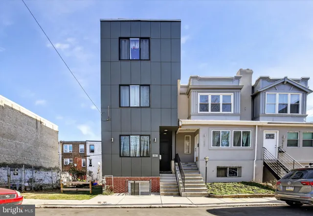 a front view of a residential apartment building with a yard