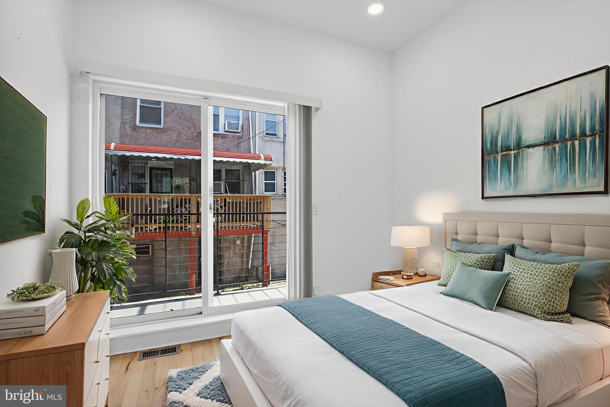1445 South 32nd Street, Unit 1 Philadelphia, PA 19146 - Photo 3 of 23 a bedroom with a bed table flowerpot and window