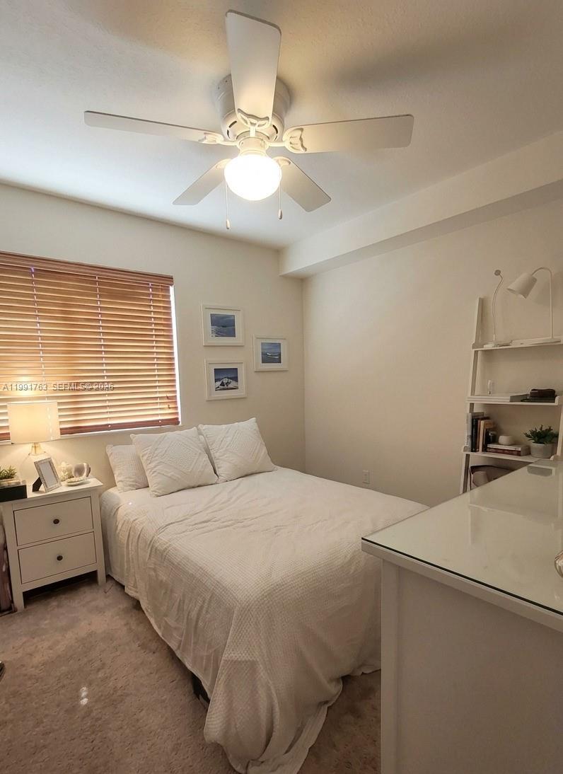 816 Northwest 11th Street, Unit 806 Miami, FL 33136 - Photo 6 of 12 a bedroom with a bed and a chandelier