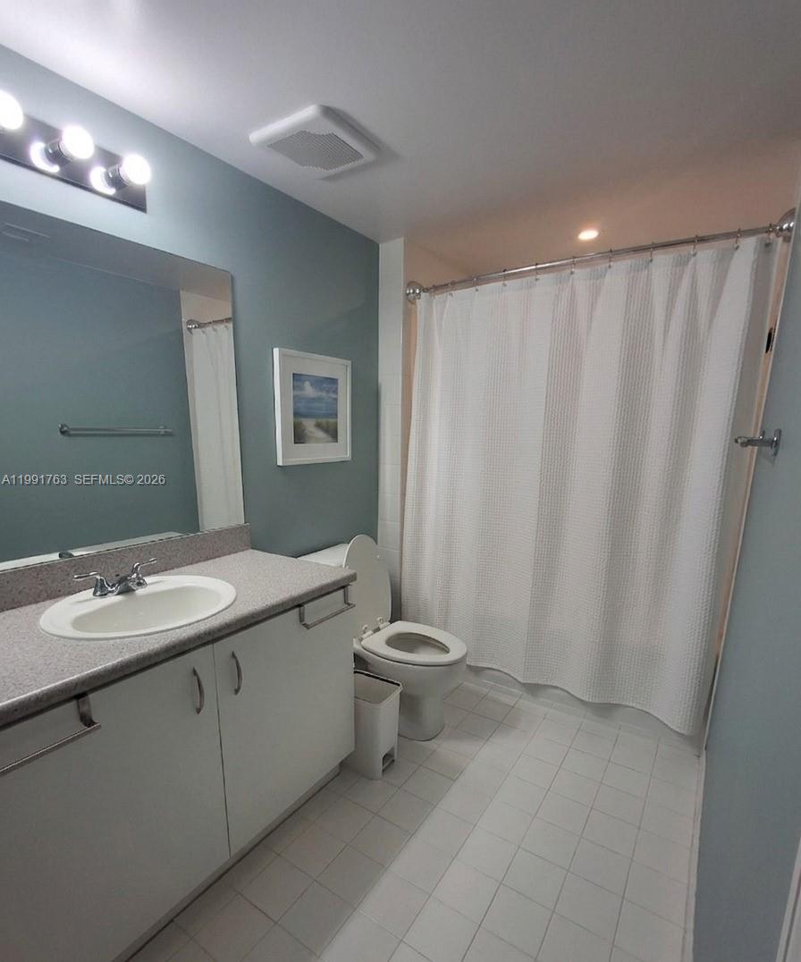 816 Northwest 11th Street, Unit 806 Miami, FL 33136 - Photo 7 of 12 a bathroom with a double vanity sink and a mirror