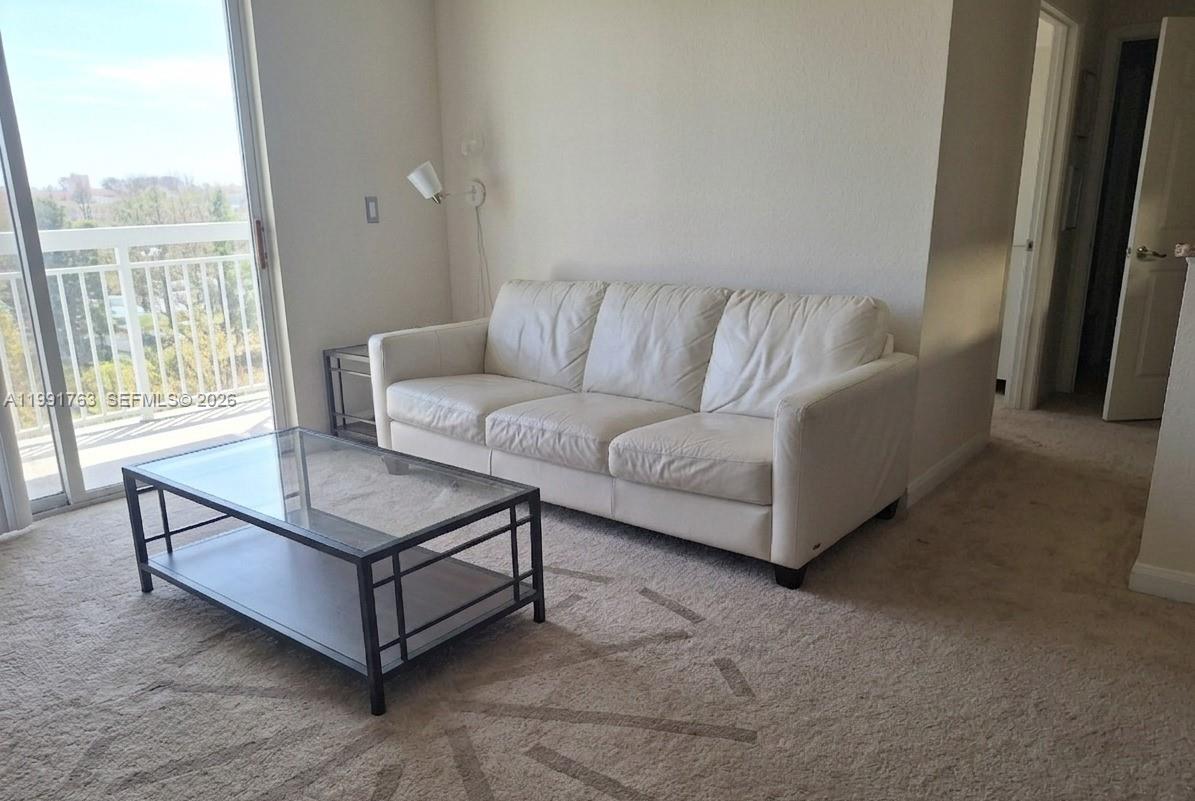 816 Northwest 11th Street, Unit 806 Miami, FL 33136 - Photo 8 of 12 a living room with furniture and a window