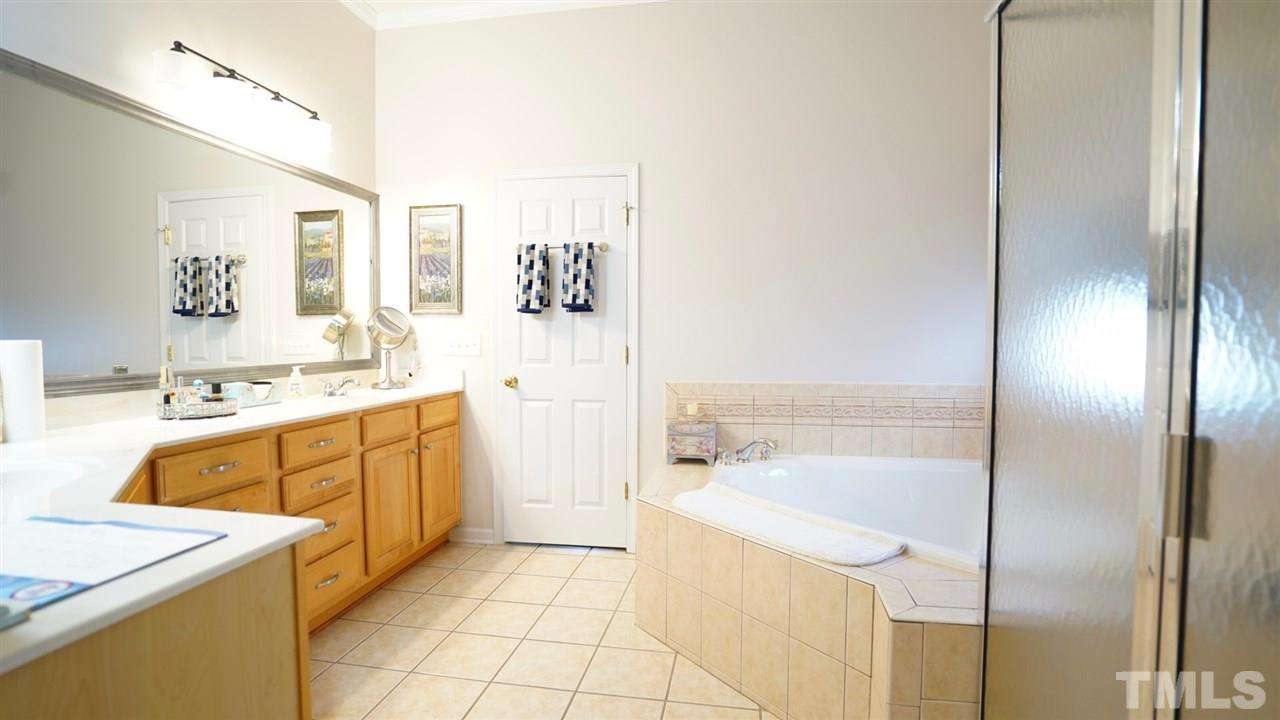 116 Okamato Street Raleigh, NC 27603 - Photo 13 of 19 a spacious bathroom with a tub sink and mirror