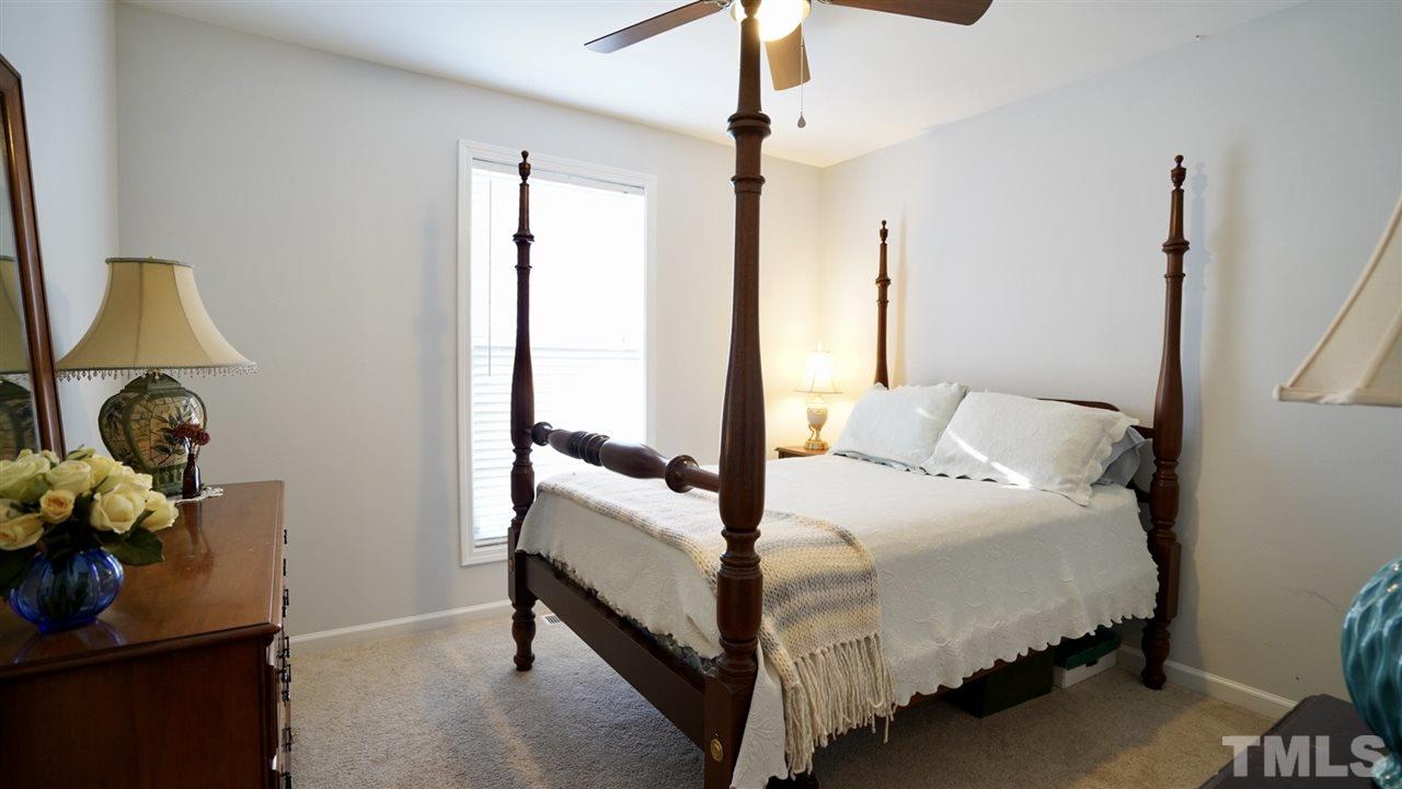 116 Okamato Street Raleigh, NC 27603 - Photo 16 of 19 a bedroom with a bed and a mirror