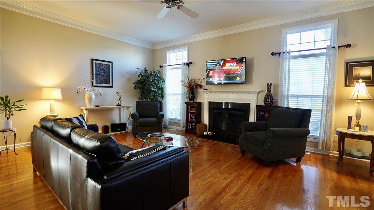116 Okamato Street Raleigh, NC 27603 - Photo 6 of 19 a living room with furniture and a fireplace
