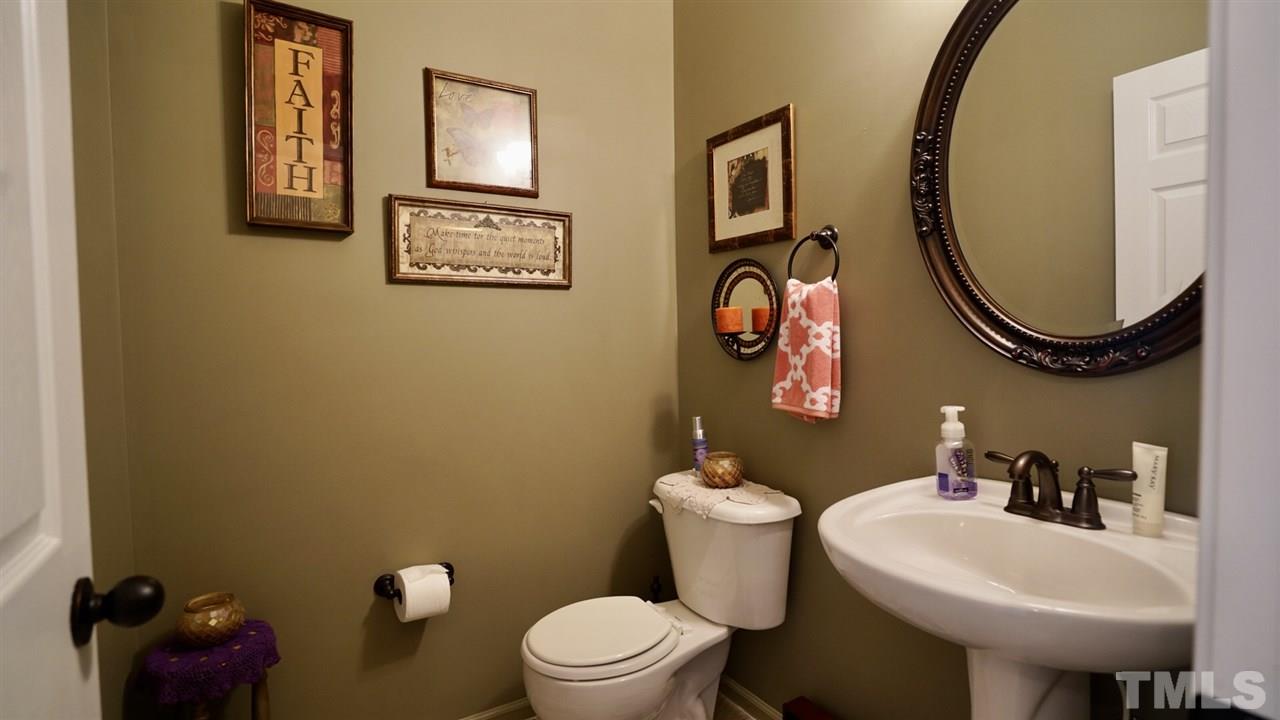 116 Okamato Street Raleigh, NC 27603 - Photo 10 of 19 a bathroom with a toilet sink and mirror