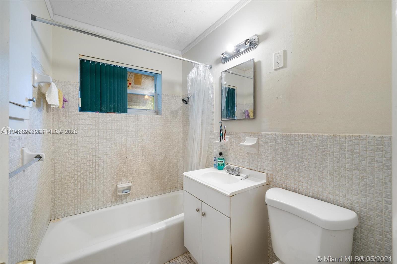 438 Northwest 93rd Street, Unit 440 Miami, FL 33150 - Photo 13 of 13 a bathroom with a sink a toilet and shower