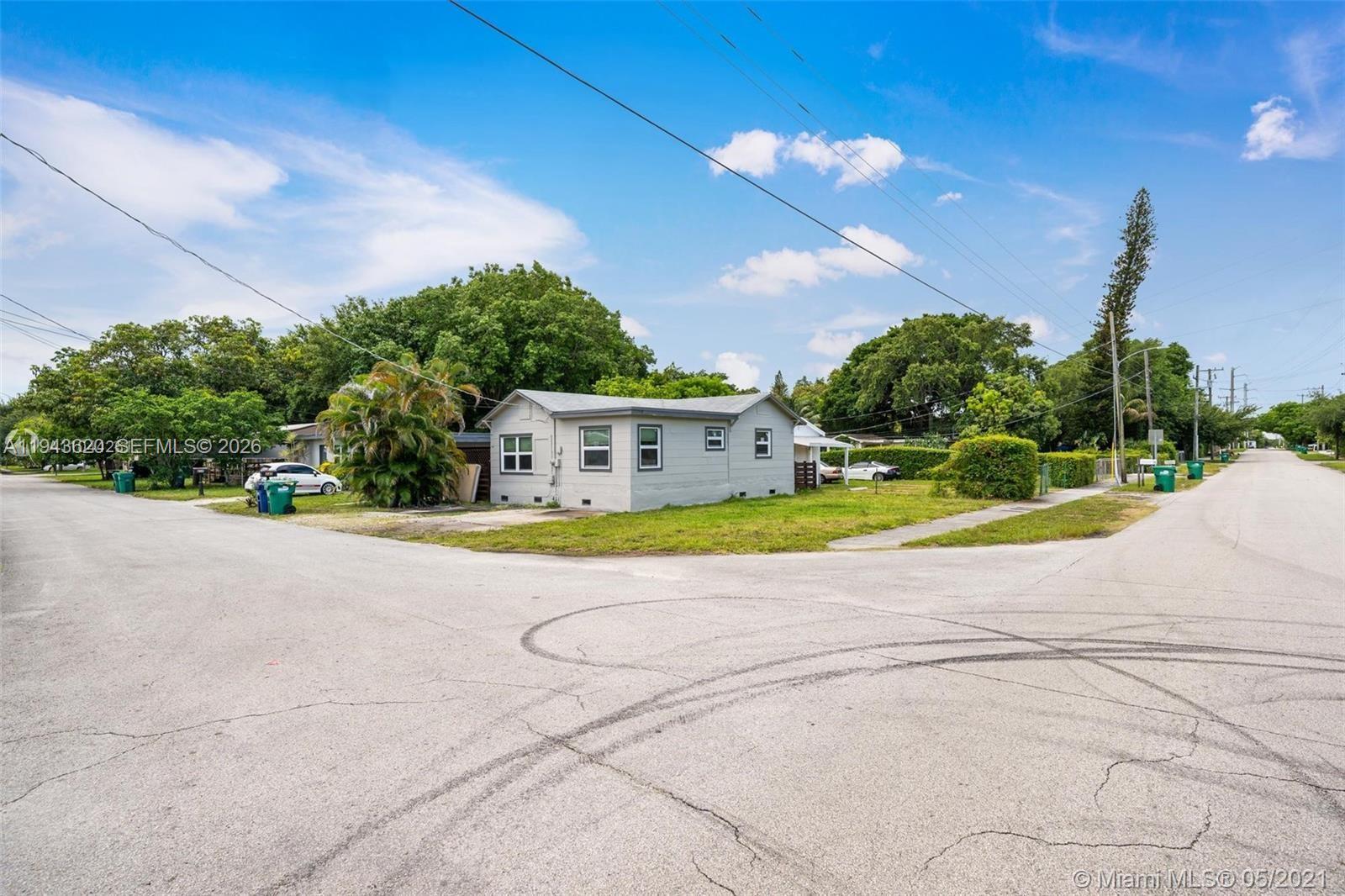 438 Northwest 93rd Street, Unit 440 Miami, FL 33150 - Photo 2 of 13 a view of a house with a yard and a basketball court