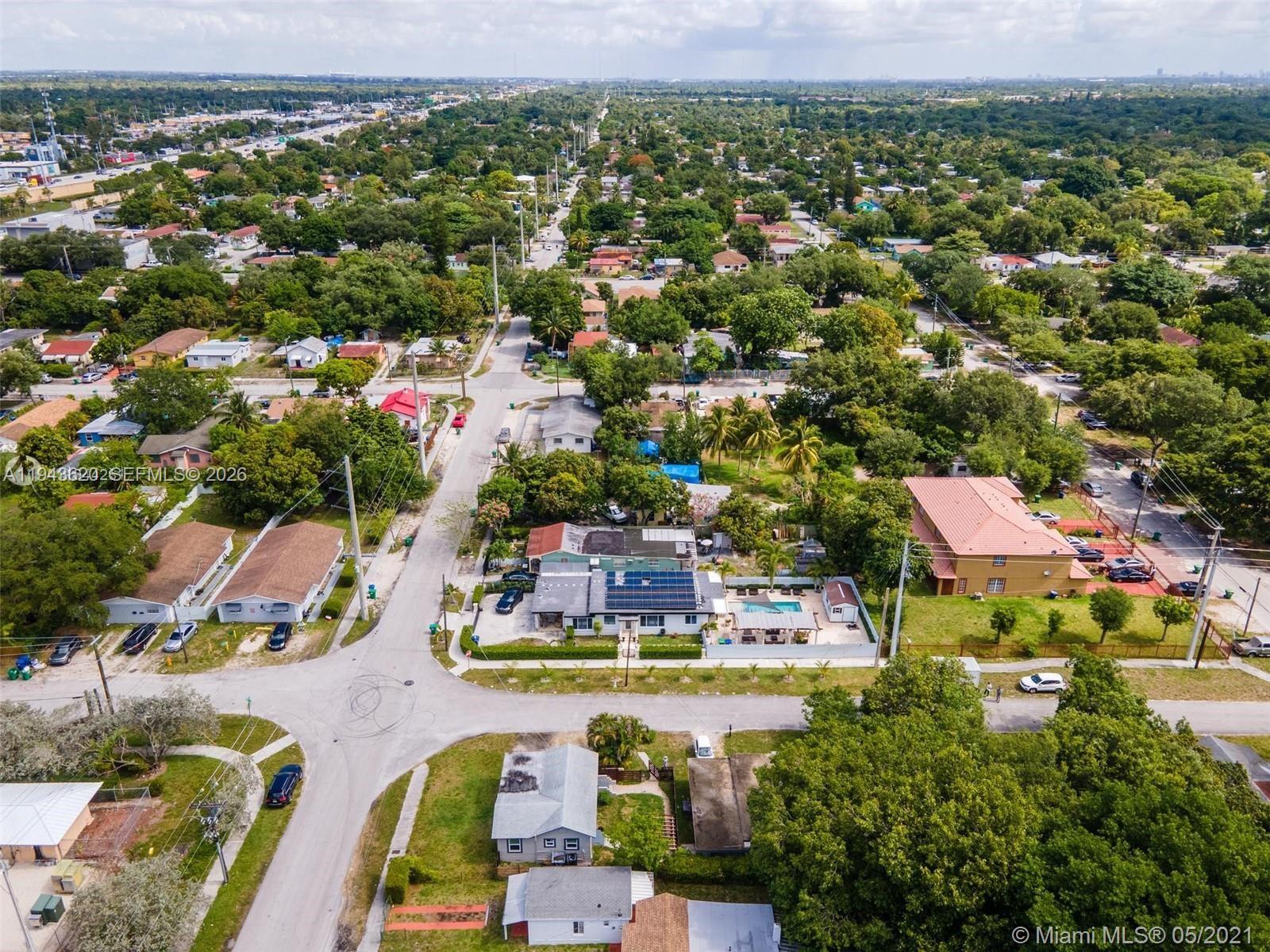 438 Northwest 93rd Street, Unit 440 Miami, FL 33150 - Photo 3 of 13 an aerial view of residential houses with outdoor space and swimming pool