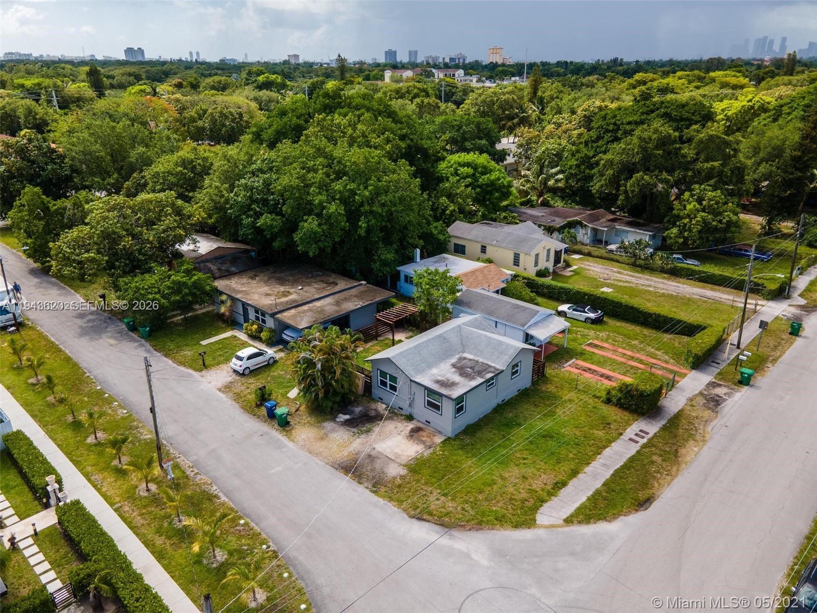 438 Northwest 93rd Street, Unit 440 Miami, FL 33150 - Photo 4 of 13 an aerial view of a house with a garden and swimming pool