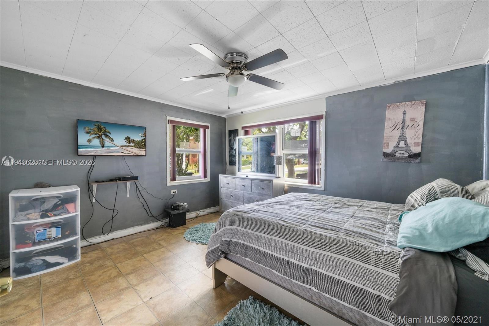 438 Northwest 93rd Street, Unit 440 Miami, FL 33150 - Photo 10 of 13 a bedroom with a bed and dresser