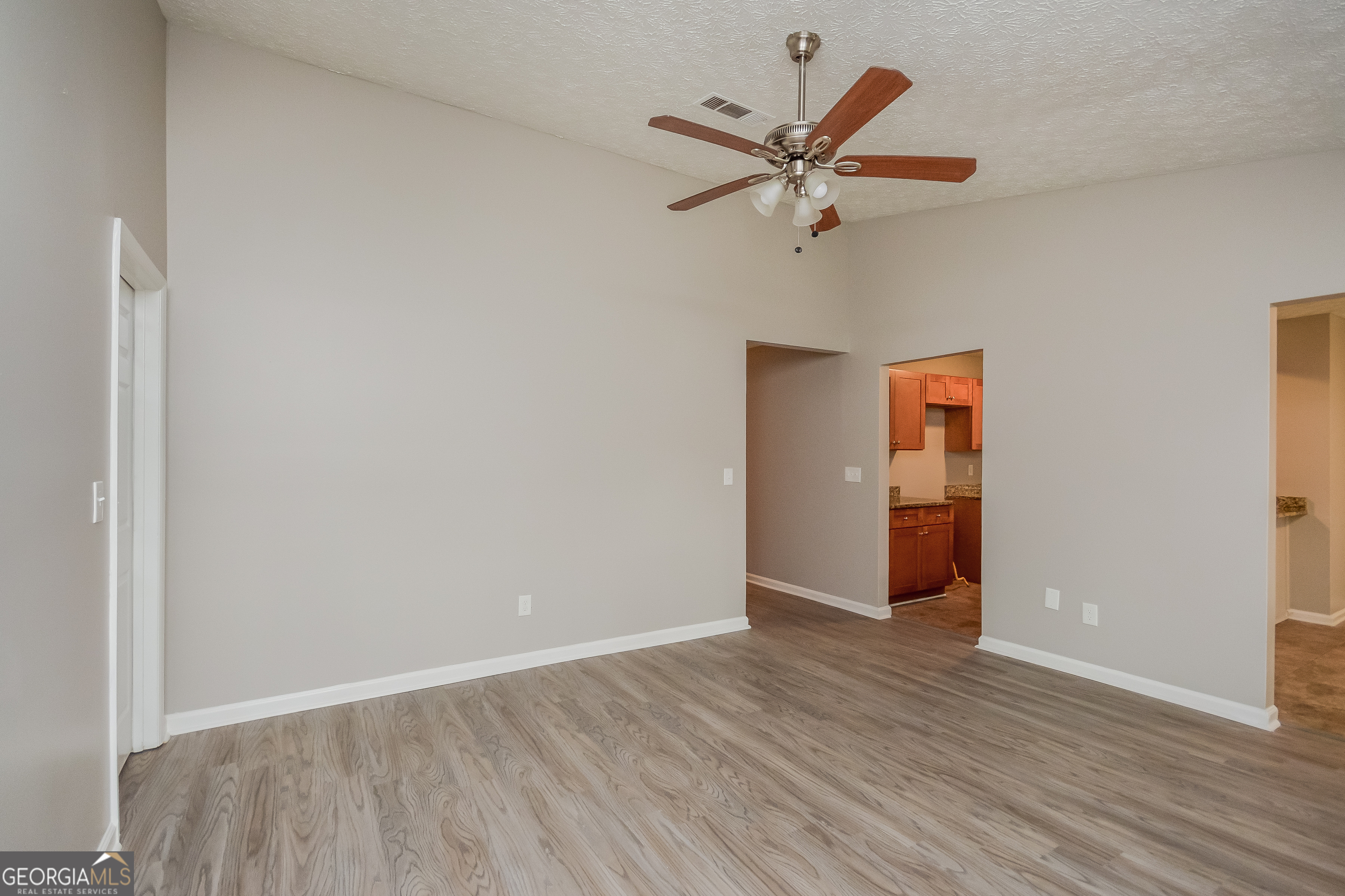 5456 Panola Downs Road Lithonia, GA 30058 - Photo 4 of 16 a view of a room with wooden floor and a ceiling fan
