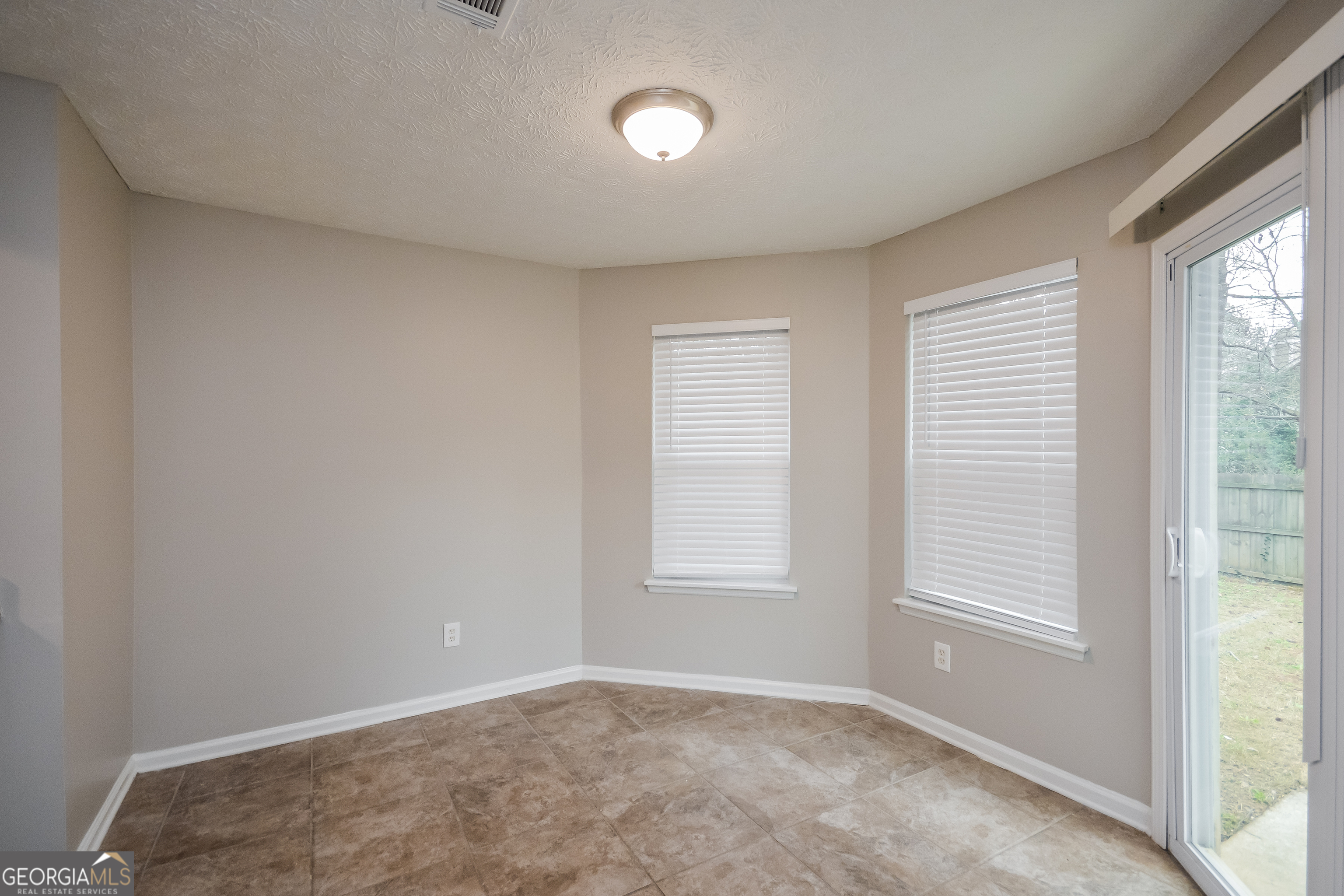 5456 Panola Downs Road Lithonia, GA 30058 - Photo 5 of 16 a view of an empty room with a window