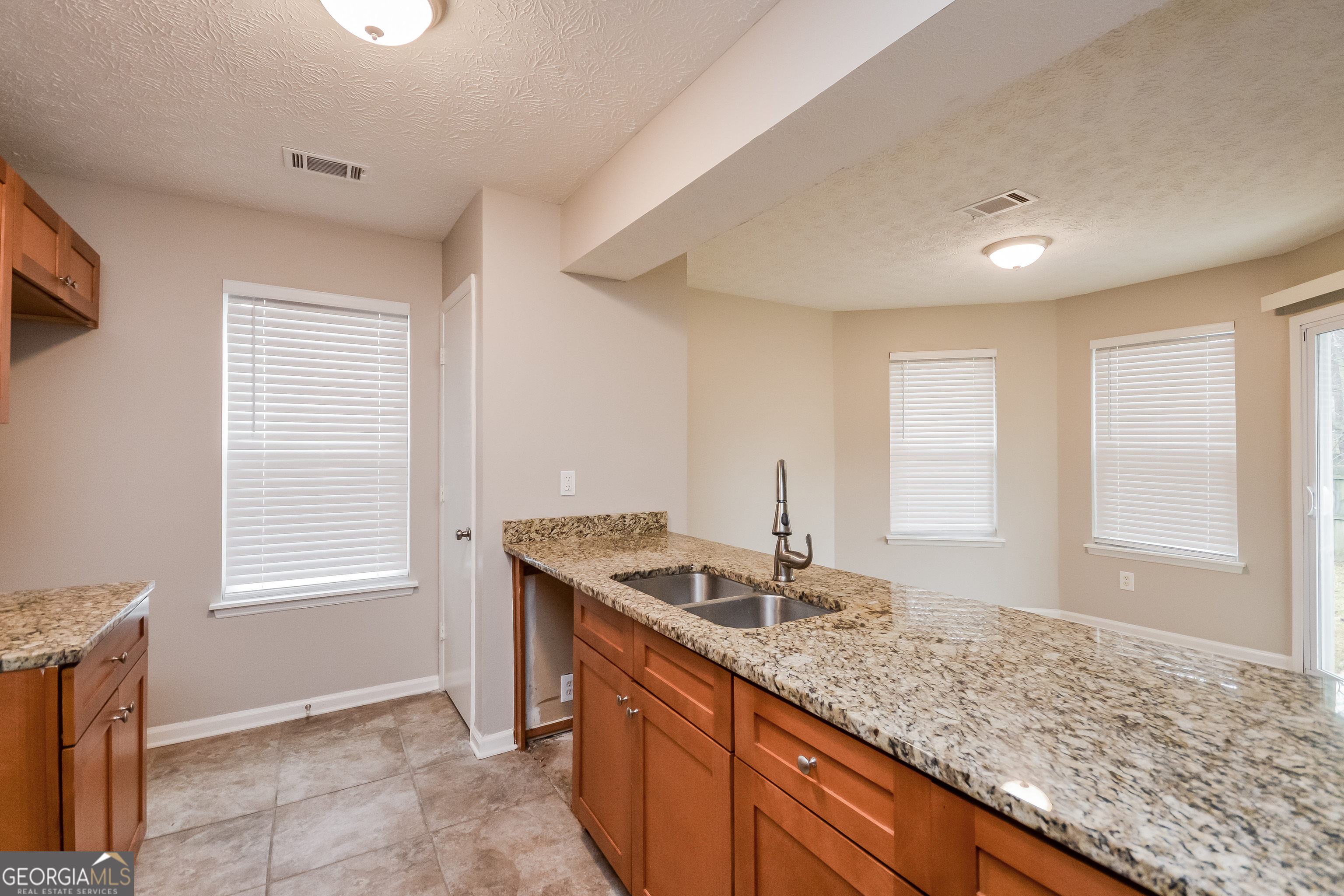 5456 Panola Downs Road Lithonia, GA 30058 - Photo 7 of 16 a bathroom with a granite countertop sink and a window