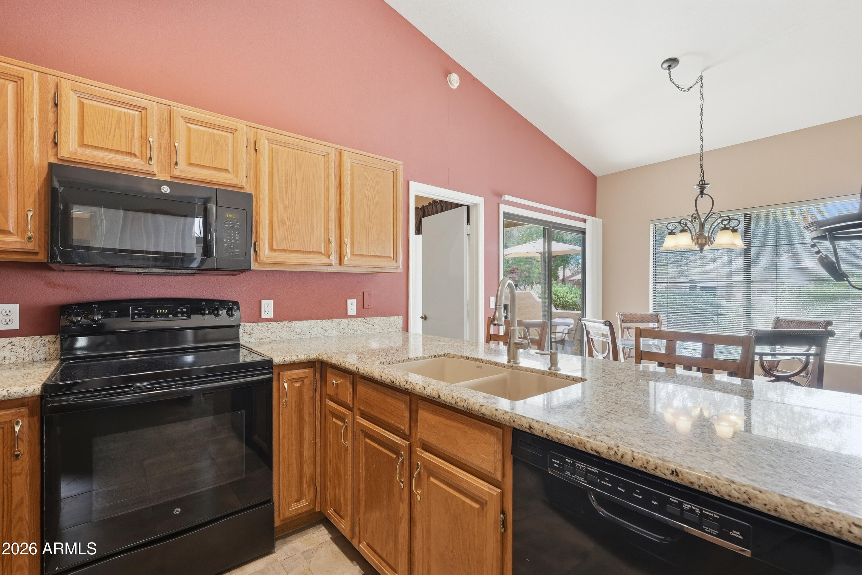 14300 West Bell Road, Unit 387 Surprise, AZ 85374 - Photo 8 of 18 a kitchen with stainless steel appliances granite countertop a stove a sink and a microwave