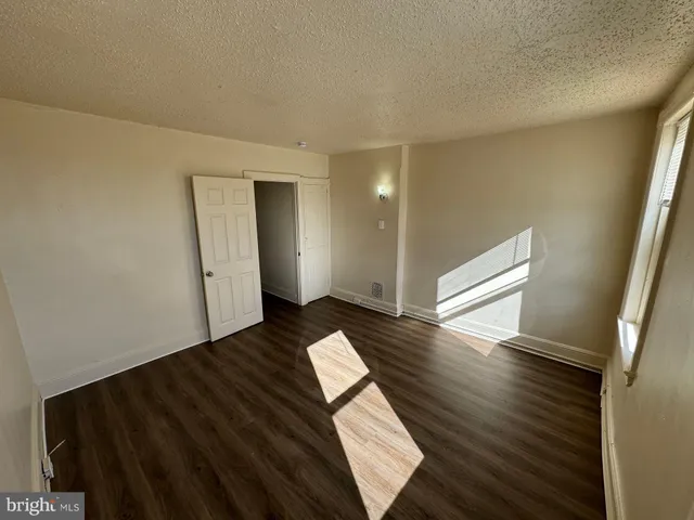 a view of wooden floor and windows in a room