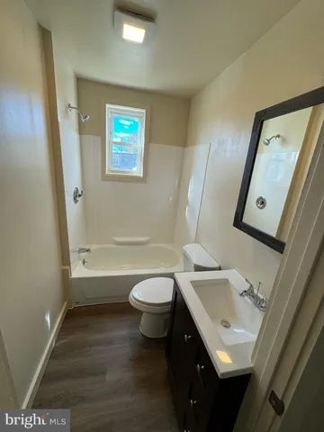 a bathroom with a sink toilet and tub