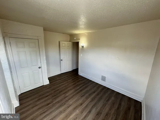 a view of an empty room and wooden floor