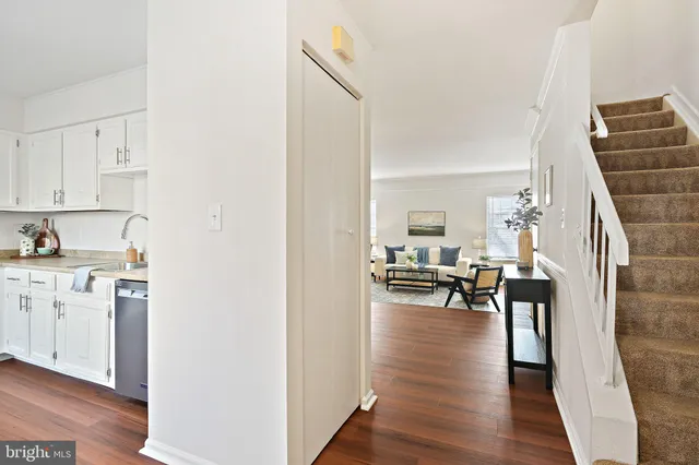 a view of living room with furniture and wooden floor