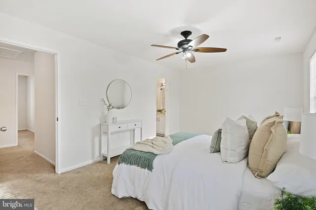 a bedroom with a bed and closet with wooden floor