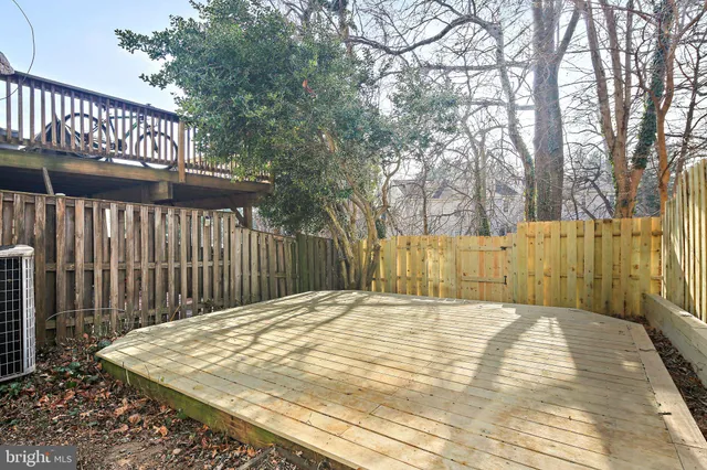 a view of backyard with wooden fence