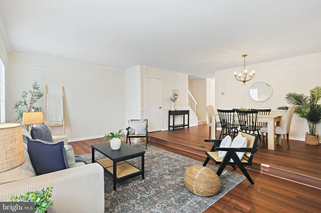 a living room with furniture a rug and a chandelier